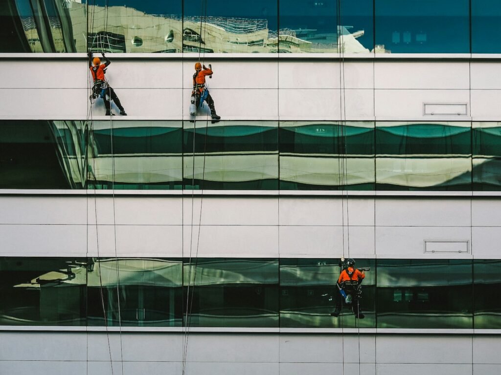 Technician cleaning the exterior facade of a building