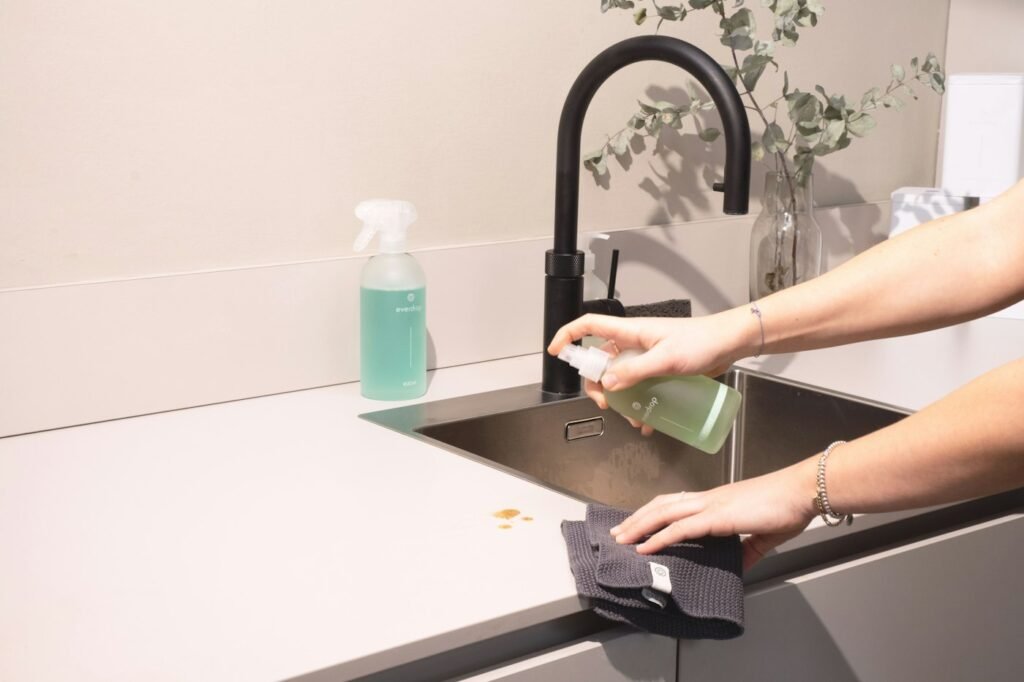 Cleaner wiping a kitchen sink