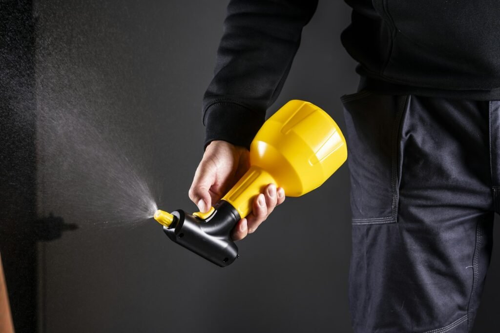 Technician holding a sprayer for pest control